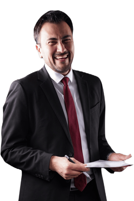 Dr. Gurgen Petrossian in a dark suit with a red tie, laughing, holding documents and a pen